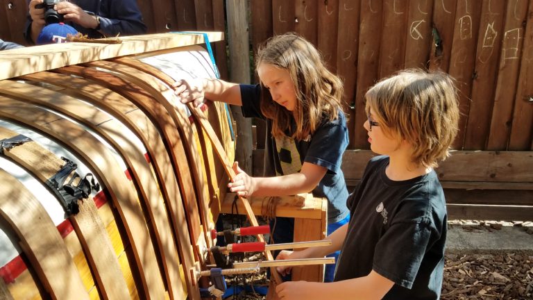 kids building a canoe