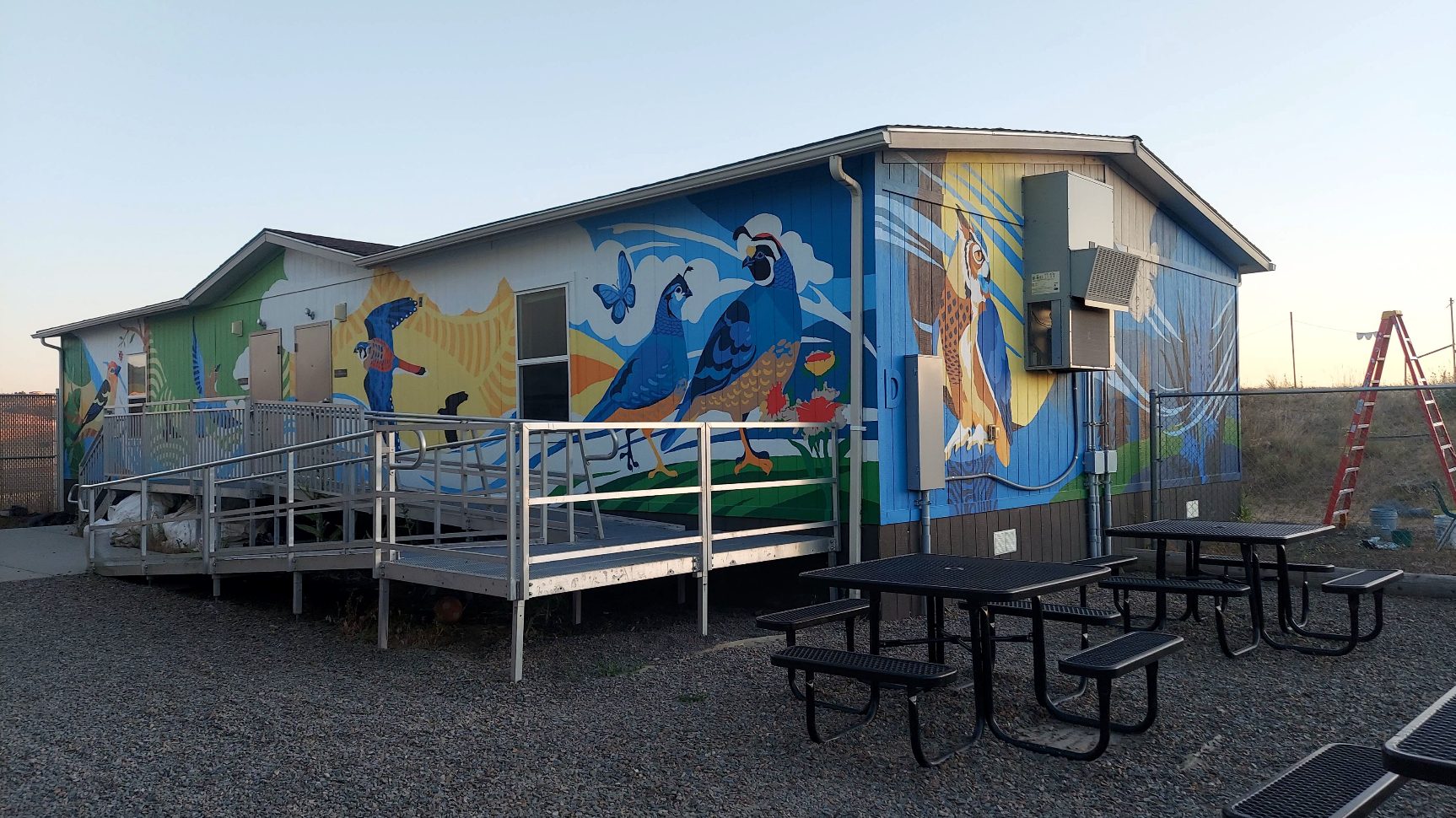building with a mural of palouse prairie animals and plants painted on it